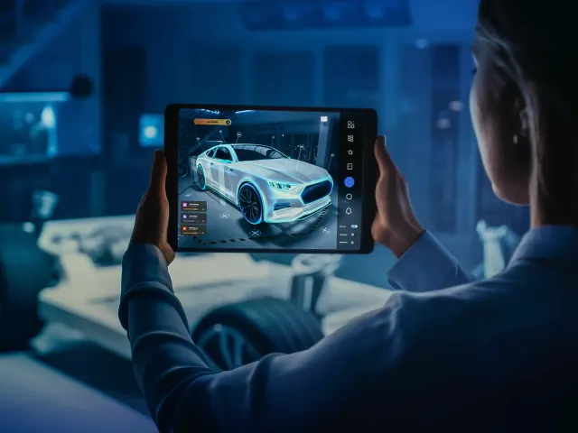 Engineer reviewing a digital twin on a tablet